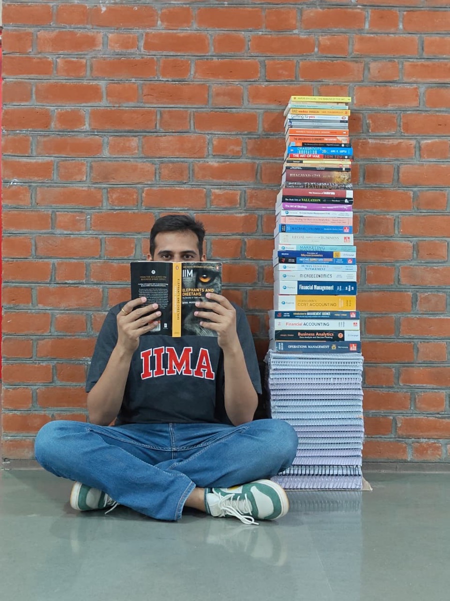 Chirag at IIM Ahmedabad with a stack of course books
